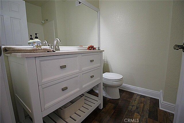 6102 Cabriolet Ct, Quartz Hill, CA 93536 - bathroom featuring wood finished floors, baseboards, toilet, and vanity