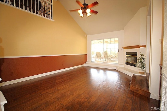 6102 Cabriolet Ct, Quartz Hill, CA 93536 - unfurnished living room featuring ceiling fan, a tile fireplace, wood finished floors, baseboards, and high vaulted ceiling
