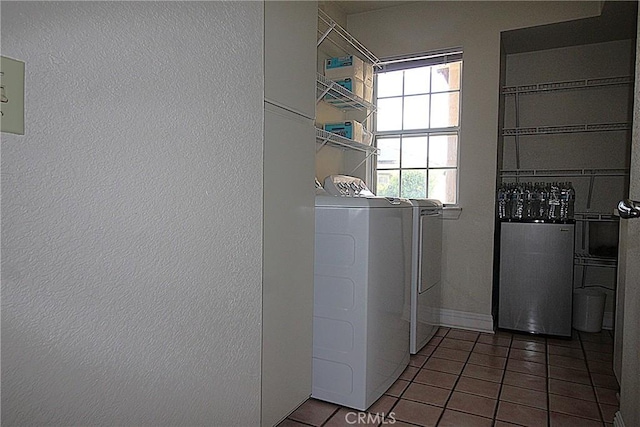 6102 Cabriolet Ct, Quartz Hill, CA 93536 - washroom featuring separate washer and dryer, tile patterned flooring, and baseboards