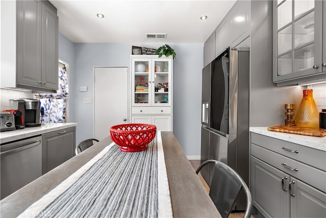 13611 Walnut St, Whittier, CA 90602 - kitchen featuring gray cabinets, appliances with stainless steel finishes, glass insert cabinets, tasteful backsplash, and recessed lighting