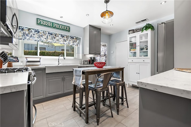 13611 Walnut St, Whittier, CA 90602 - kitchen featuring gray cabinetry, backsplash, appliances with stainless steel finishes, recessed lighting, and hanging light fixtures