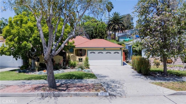 13611 Walnut St, Whittier, CA 90602 - view of front of home with a garage, concrete driveway, and stucco siding