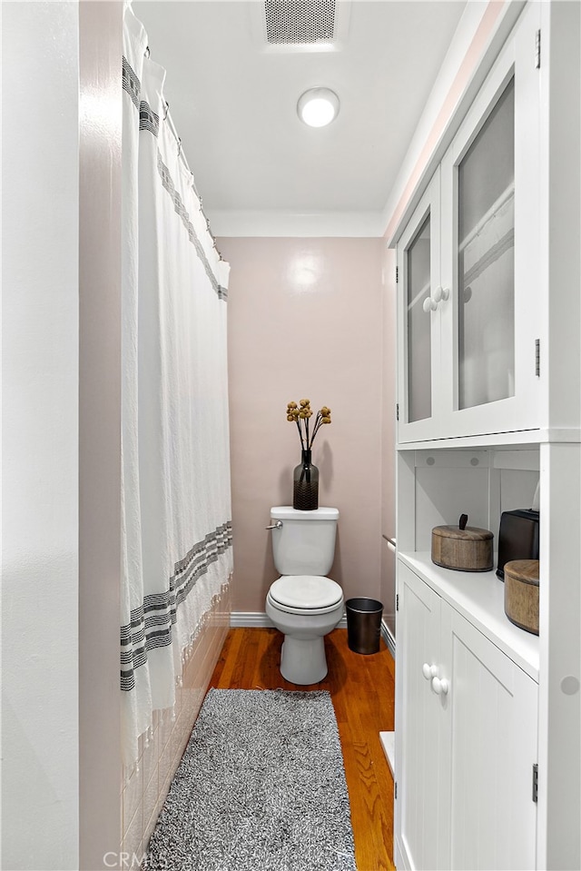 13611 Walnut St, Whittier, CA 90602 - full bath featuring toilet, wood finished floors, vanity, and a shower with shower curtain