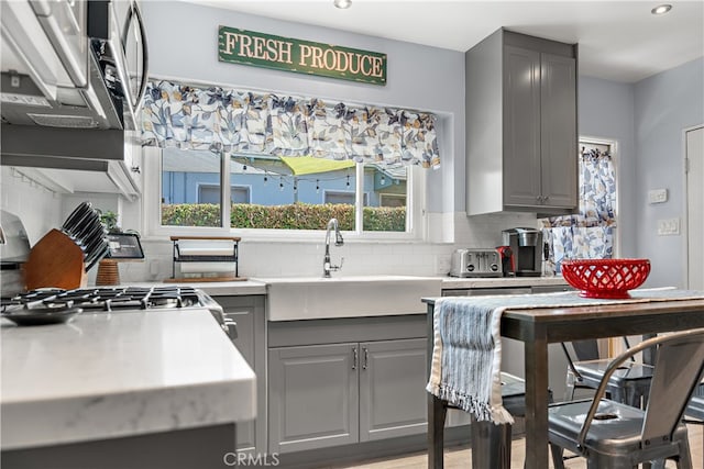 13611 Walnut St, Whittier, CA 90602 - kitchen with gray cabinetry, a sink, tasteful backsplash, recessed lighting, and light countertops
