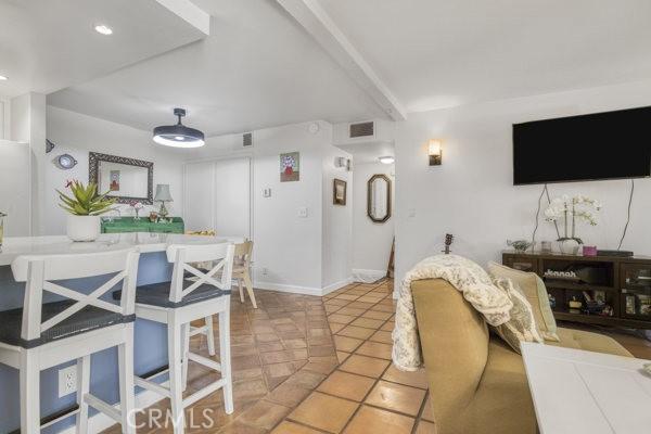 15155 Sherman Way Unit 14, Van Nuys, CA 91405 - living room with light tile patterned flooring and baseboards