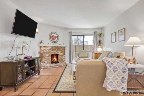 15155 Sherman Way Unit 14, Van Nuys, CA 91405 - living room featuring a brick fireplace and tile patterned floors