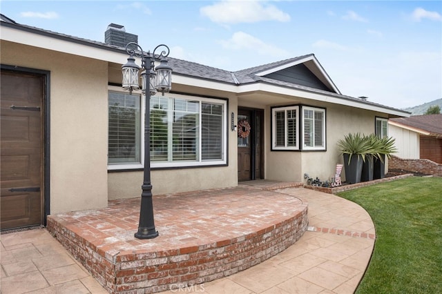 1325 N Birchnell Ave, San Dimas, CA 91773 - property entrance featuring stucco siding, a patio area, and a chimney