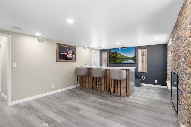 1325 N Birchnell Ave, San Dimas, CA 91773 - indoor wet bar with wood finished floors, a stone fireplace, baseboards, and recessed lighting