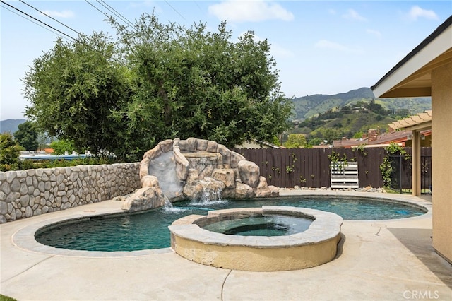1325 N Birchnell Ave, San Dimas, CA 91773 - view of swimming pool with a mountain view, fence, a pool with connected hot tub, and a patio area
