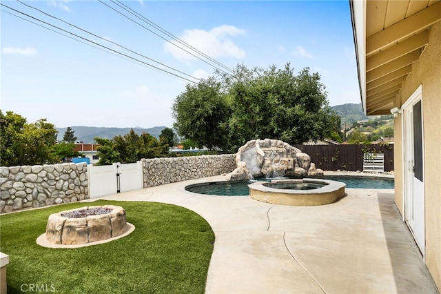 1325 N Birchnell Ave, San Dimas, CA 91773 - view of patio / terrace with a fire pit, a mountain view, a pool with connected hot tub, and a gate