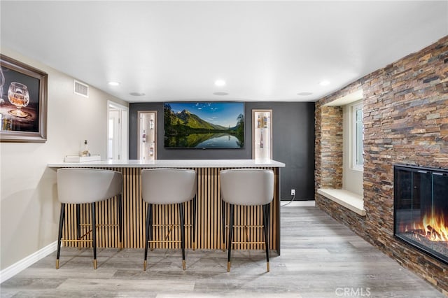 1325 N Birchnell Ave, San Dimas, CA 91773 - indoor bar featuring a stone fireplace, wood finished floors, baseboards, and recessed lighting