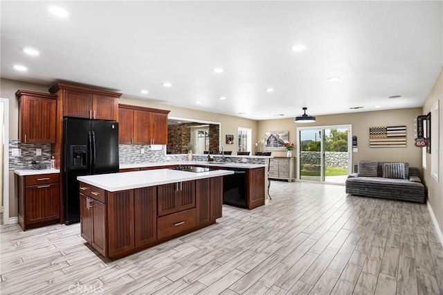 1325 N Birchnell Ave, San Dimas, CA 91773 - kitchen featuring black appliances, a center island, light countertops, open floor plan, and a peninsula