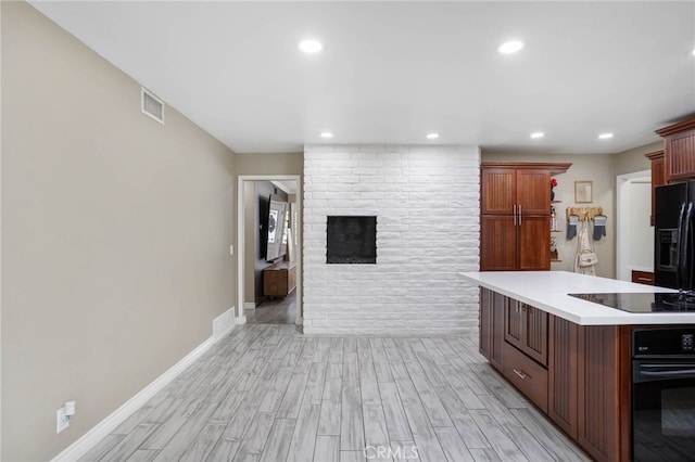 1325 N Birchnell Ave, San Dimas, CA 91773 - kitchen featuring black appliances, light countertops, light wood finished floors, a fireplace, and recessed lighting