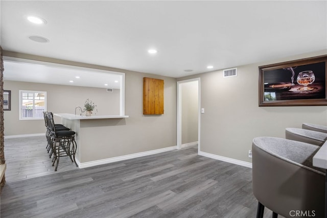 1325 N Birchnell Ave, San Dimas, CA 91773 - kitchen with a kitchen breakfast bar, wood finished floors, recessed lighting, baseboards, and a sink