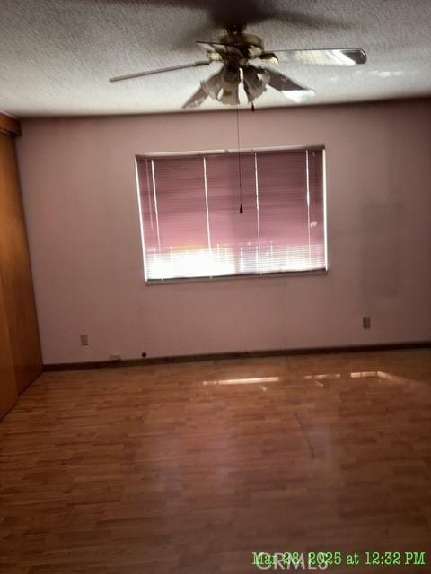 17216 Cedar Way, Clearlake Oaks, CA 95423 - unfurnished room featuring ceiling fan, wood finished floors, baseboards, and a textured ceiling