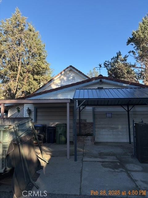 17216 Cedar Way, Clearlake Oaks, CA 95423 - view of property exterior featuring a garage and metal roof