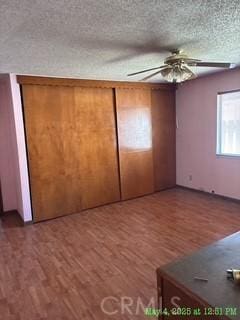 17216 Cedar Way, Clearlake Oaks, CA 95423 - unfurnished bedroom with wood finished floors, a textured ceiling, and ceiling fan