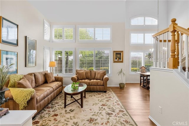 27567 Courtview Dr, Valencia, CA 91354 - living room with a towering ceiling, wood finished floors, stairs, and baseboards