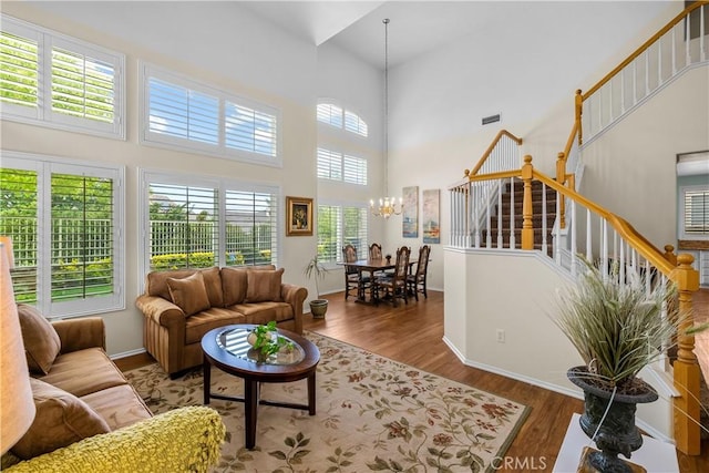 27567 Courtview Dr, Valencia, CA 91354 - living room with a towering ceiling, a chandelier, wood finished floors, stairway, and baseboards