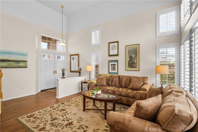27567 Courtview Dr, Valencia, CA 91354 - living area featuring a high ceiling, wood finished floors, and baseboards