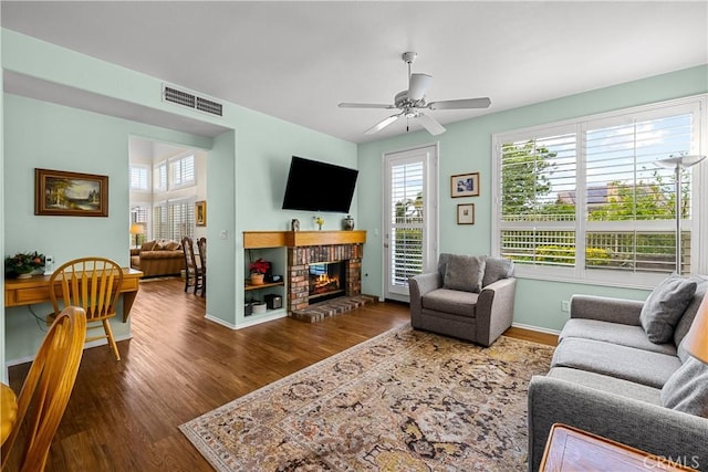 27567 Courtview Dr, Valencia, CA 91354 - living area with wood finished floors, a ceiling fan, a fireplace, and baseboards