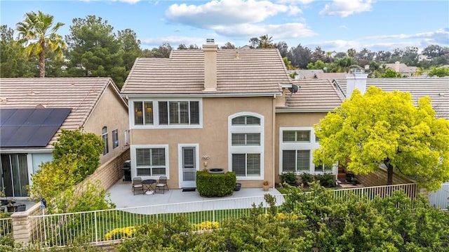 27567 Courtview Dr, Valencia, CA 91354 - back of house with a chimney, stucco siding, a patio area, and fence