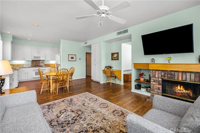 27567 Courtview Dr, Valencia, CA 91354 - living area featuring dark wood-type flooring, ceiling fan, a brick fireplace, and recessed lighting
