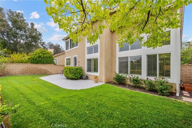 27567 Courtview Dr, Valencia, CA 91354 - rear view of property featuring stucco siding and a patio area