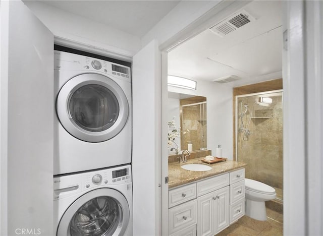 235 Main St Unit 118, Venice, CA 90291 - washroom featuring stacked washer / dryer and light tile patterned floors