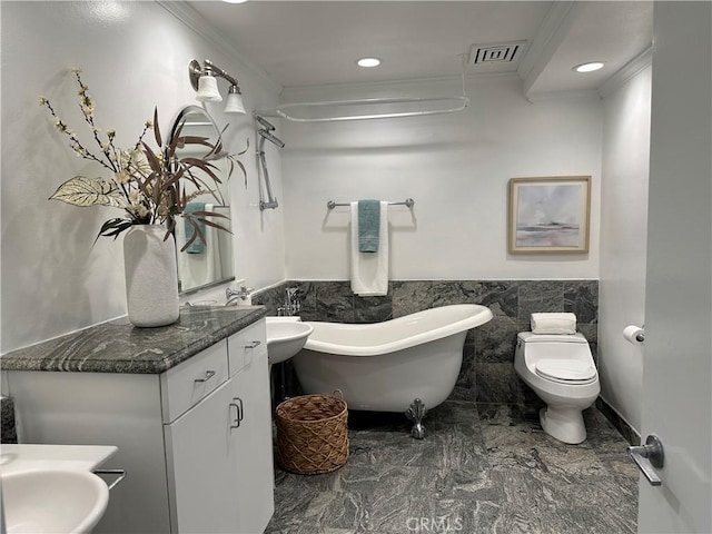 235 Main St Unit 118, Venice, CA 90291 - bathroom featuring crown molding, a freestanding bath, a wainscoted wall, tile walls, and vanity