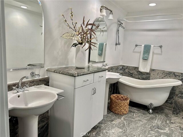 235 Main St Unit 118, Venice, CA 90291 - bathroom with a soaking tub, crown molding, wainscoting, tile walls, and marble finish flooring