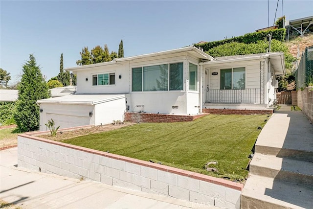 view of front of home featuring concrete driveway and stucco siding