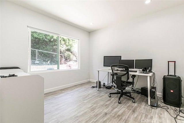 office space with light wood finished floors, baseboards, and recessed lighting