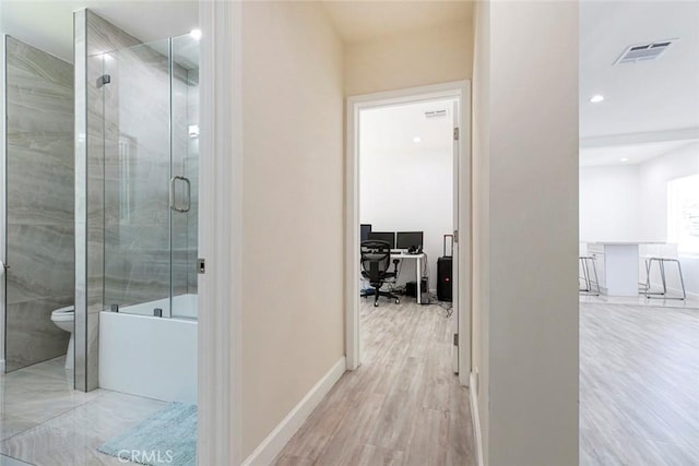corridor featuring an office area, wood finished floors, baseboards, and recessed lighting
