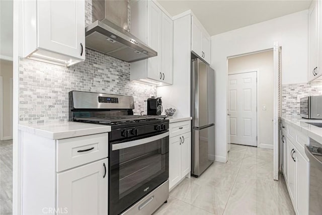 kitchen with stainless steel appliances, wall chimney exhaust hood, and white cabinetry