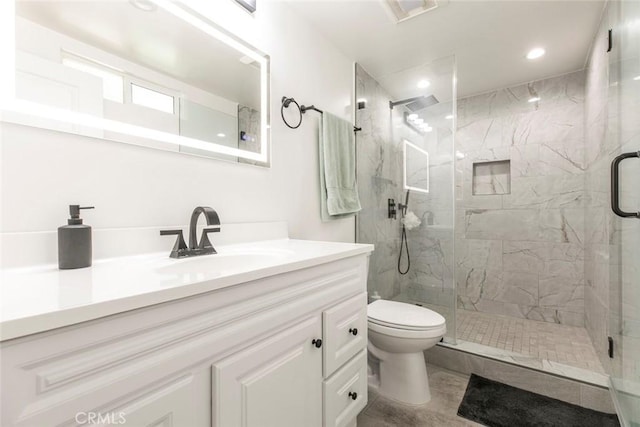 bathroom with toilet, a marble finish shower, vanity, and recessed lighting