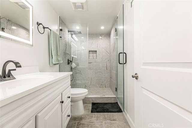 full bathroom featuring toilet, a marble finish shower, vanity, and recessed lighting