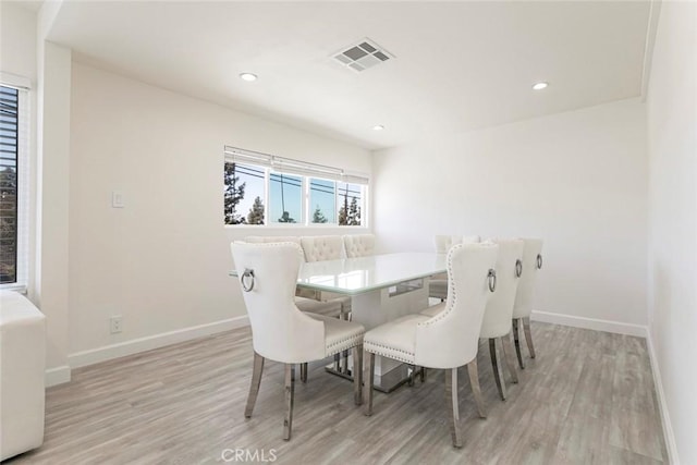 dining area with light wood finished floors, baseboards, and recessed lighting