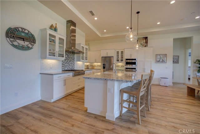 851 Trail View Pl, Nipomo, CA 93444 - kitchen featuring wall chimney range hood, stainless steel appliances, a tray ceiling, backsplash, and recessed lighting