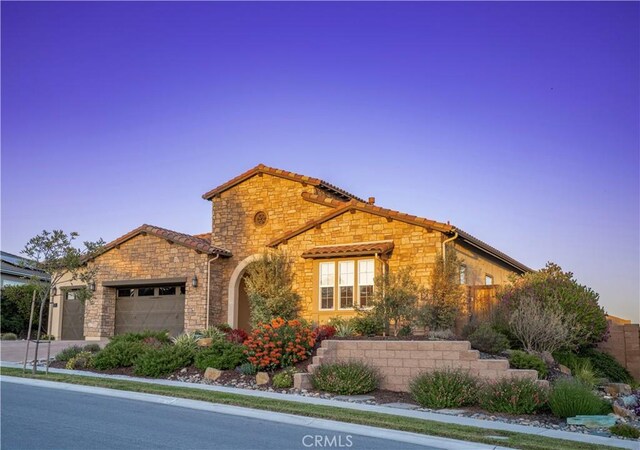851 Trail View Pl, Nipomo, CA 93444 - view of front of home featuring stone siding, an attached garage, and driveway