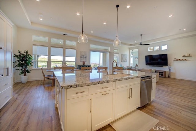 851 Trail View Pl, Nipomo, CA 93444 - kitchen featuring dishwasher, a sink, open floor plan, light wood-type flooring, and light stone countertops