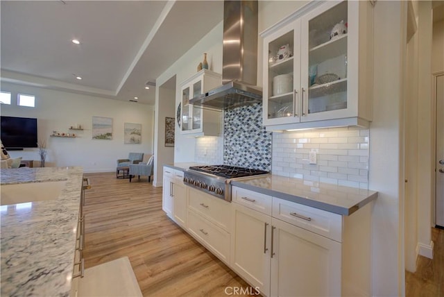 851 Trail View Pl, Nipomo, CA 93444 - kitchen with wall chimney range hood, stainless steel gas stovetop, open floor plan, light wood-style floors, and light stone counters