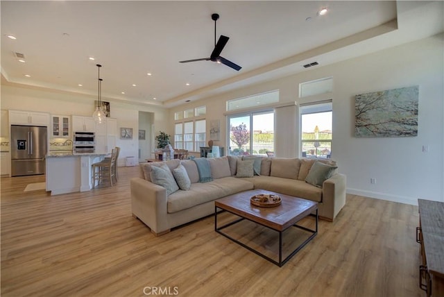 851 Trail View Pl, Nipomo, CA 93444 - living area with a tray ceiling, light wood-style floors, recessed lighting, ceiling fan, and baseboards