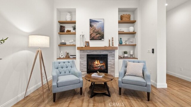 851 Trail View Pl, Nipomo, CA 93444 - sitting room featuring built in features, a tiled fireplace, and wood finished floors