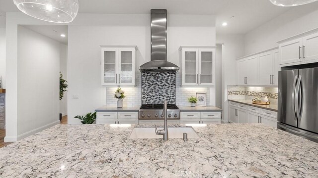 851 Trail View Pl, Nipomo, CA 93444 - kitchen with wall chimney range hood, stainless steel appliances, light stone countertops, white cabinets, and recessed lighting