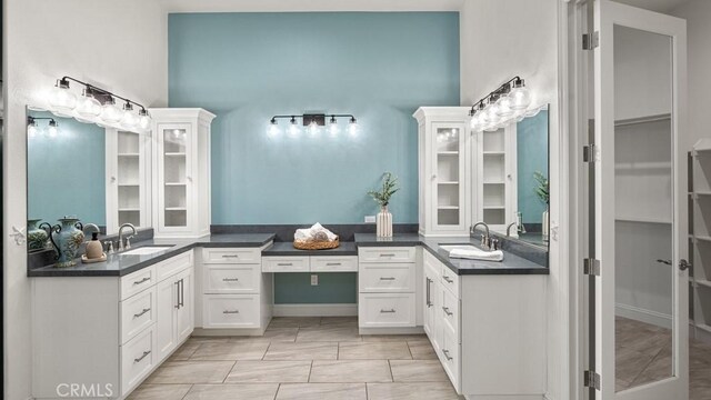 851 Trail View Pl, Nipomo, CA 93444 - full bath featuring two vanities, a walk in closet, and a towering ceiling