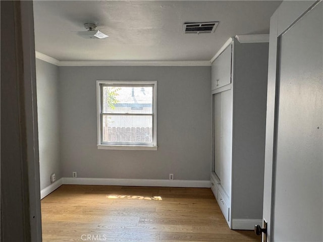 35226 Ave C, Yucaipa, CA 92399 - unfurnished bedroom with ornamental molding, light wood-style floors, and baseboards