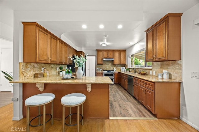 2520 Louise Ave, Arcadia, CA 91006 - kitchen with stainless steel appliances, a peninsula, light wood-style flooring, a sink, and brown cabinetry