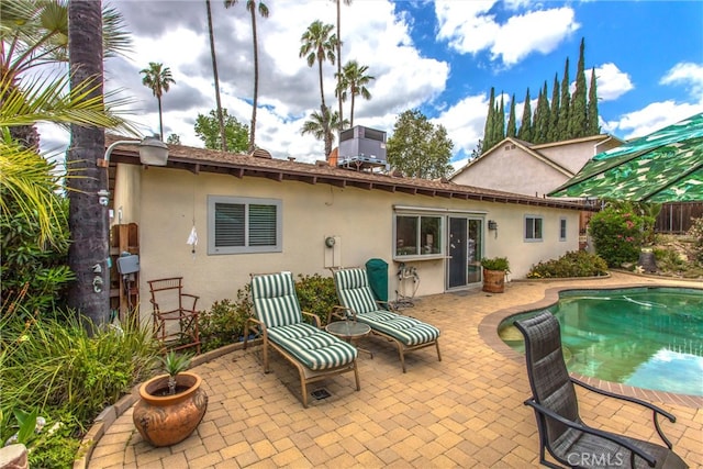 2605 La Praix St, Highland, CA 92346 - back of property featuring stucco siding, a patio area, an outdoor pool, and central AC