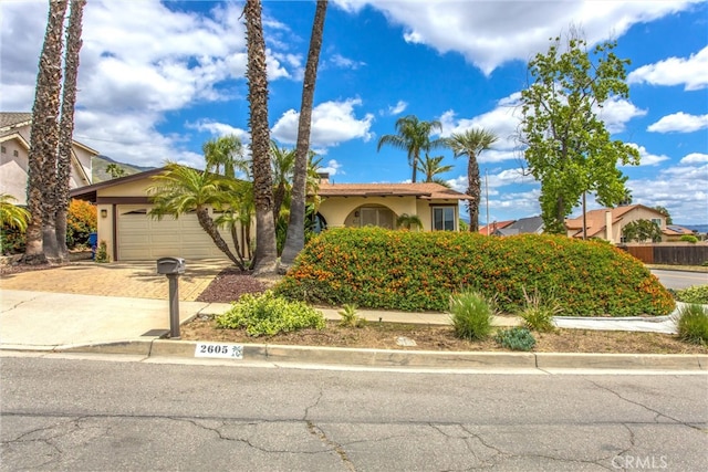 2605 La Praix St, Highland, CA 92346 - view of front of house featuring stucco siding, decorative driveway, and a garage